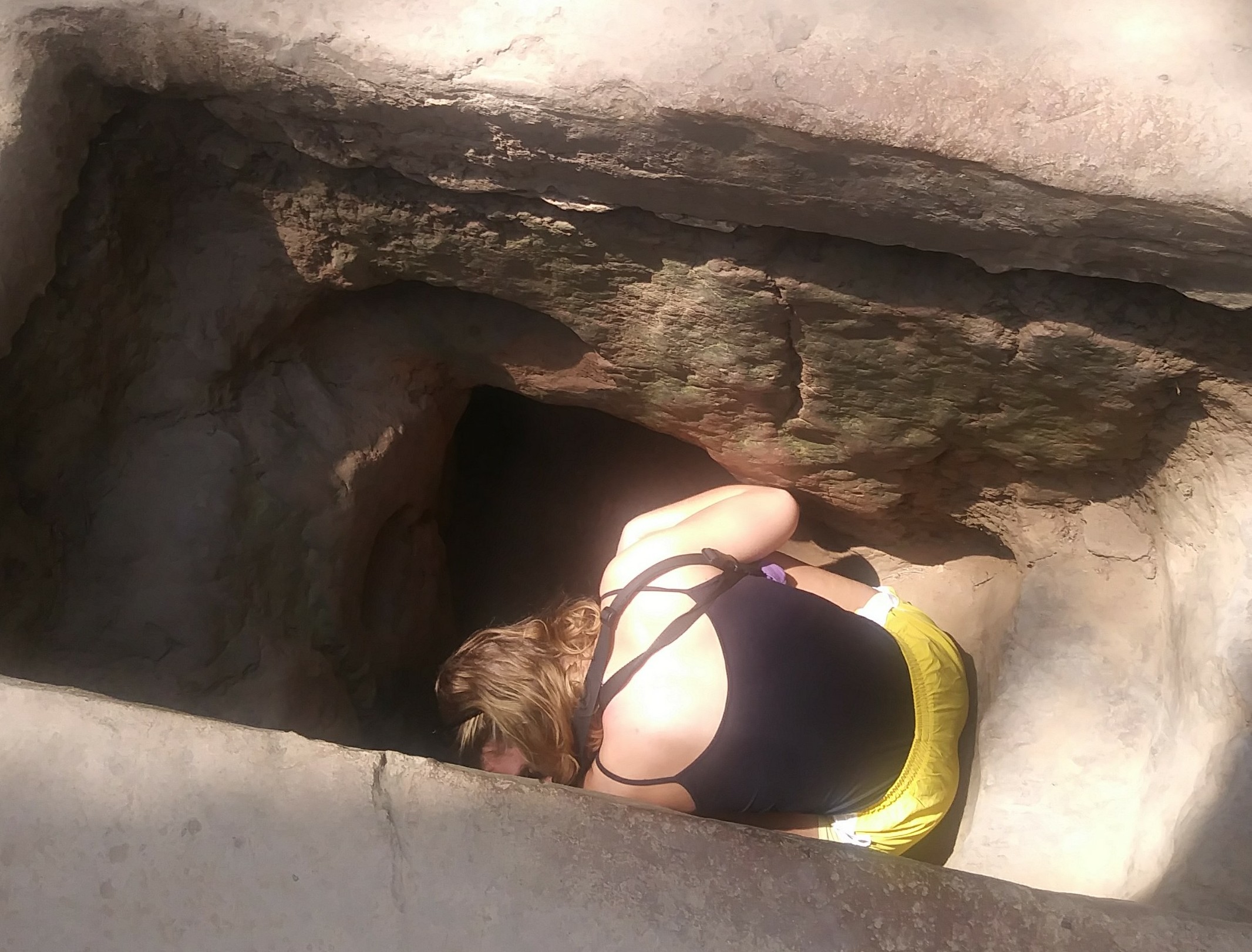 Into The Cu Chi Tunnels. Lady entering an underground tunnel.