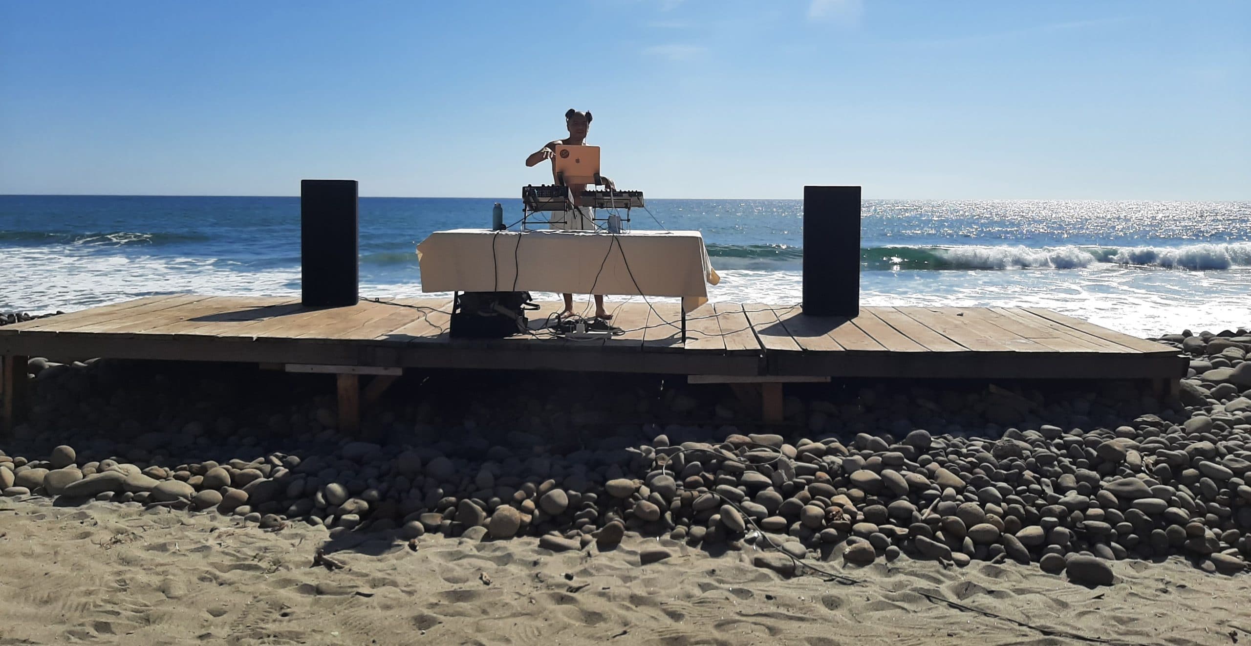 DJ on pebble stone beach in El Tunco, El Salvador